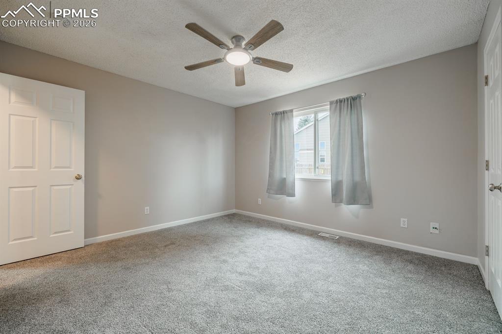 739 Memory Lane Fountain, CO 80817 - Photo 13 of 37 an empty room with windows and ceiling fan