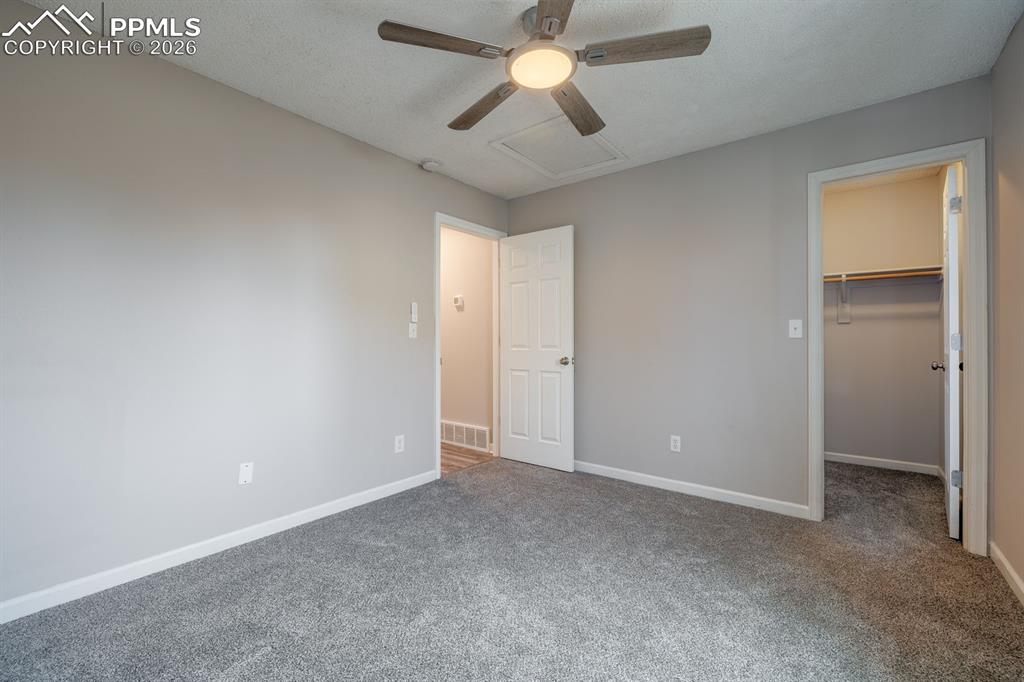 739 Memory Lane Fountain, CO 80817 - Photo 18 of 37 an empty room with closet and a chandelier fan