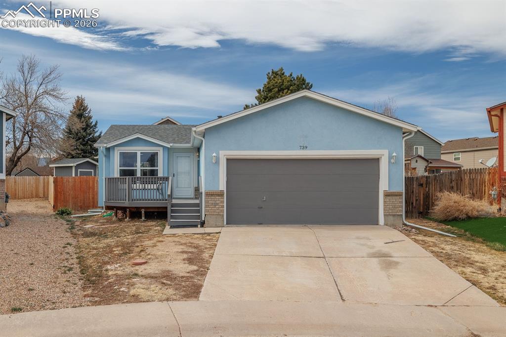 739 Memory Lane Fountain, CO 80817 - Photo 2 of 37 a front view of a house with a yard and garage