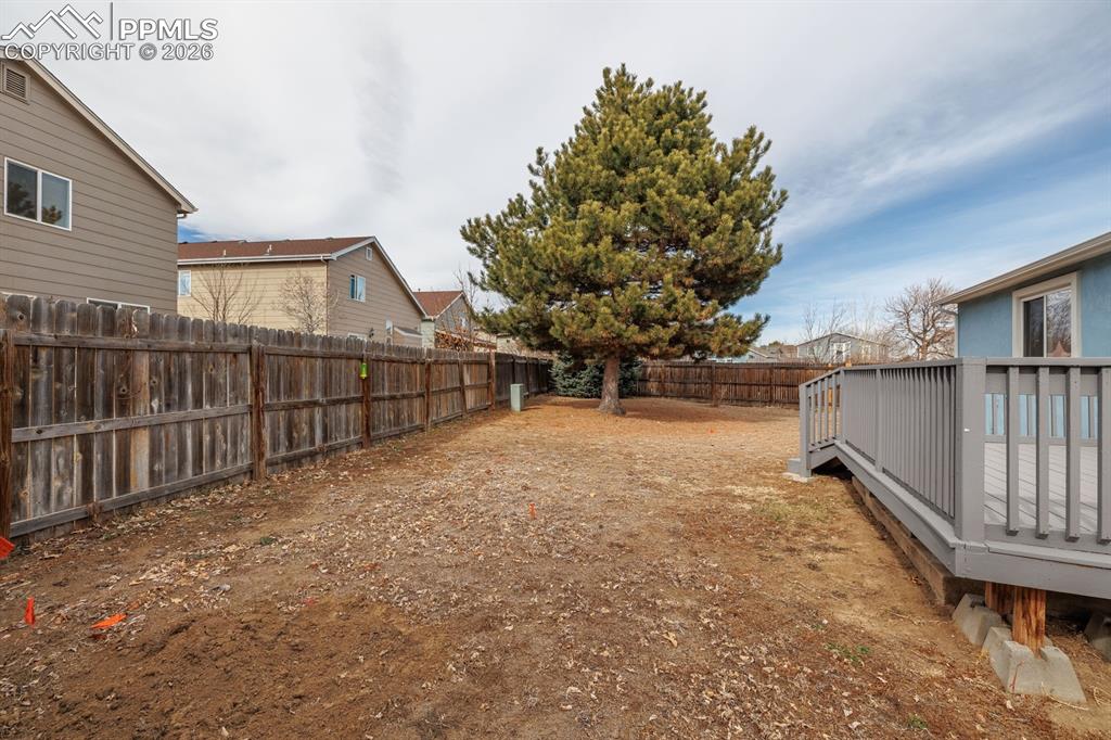 739 Memory Lane Fountain, CO 80817 - Photo 30 of 37 a view of backyard with wooden fence and large trees