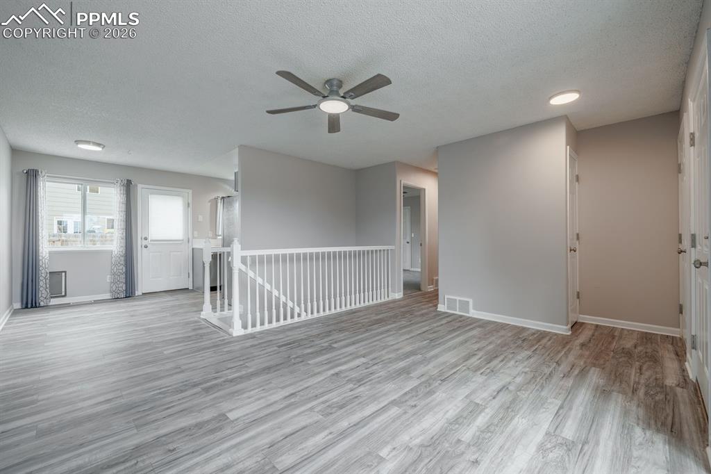739 Memory Lane Fountain, CO 80817 - Photo 6 of 37 a view of an empty room with wooden floor and a window
