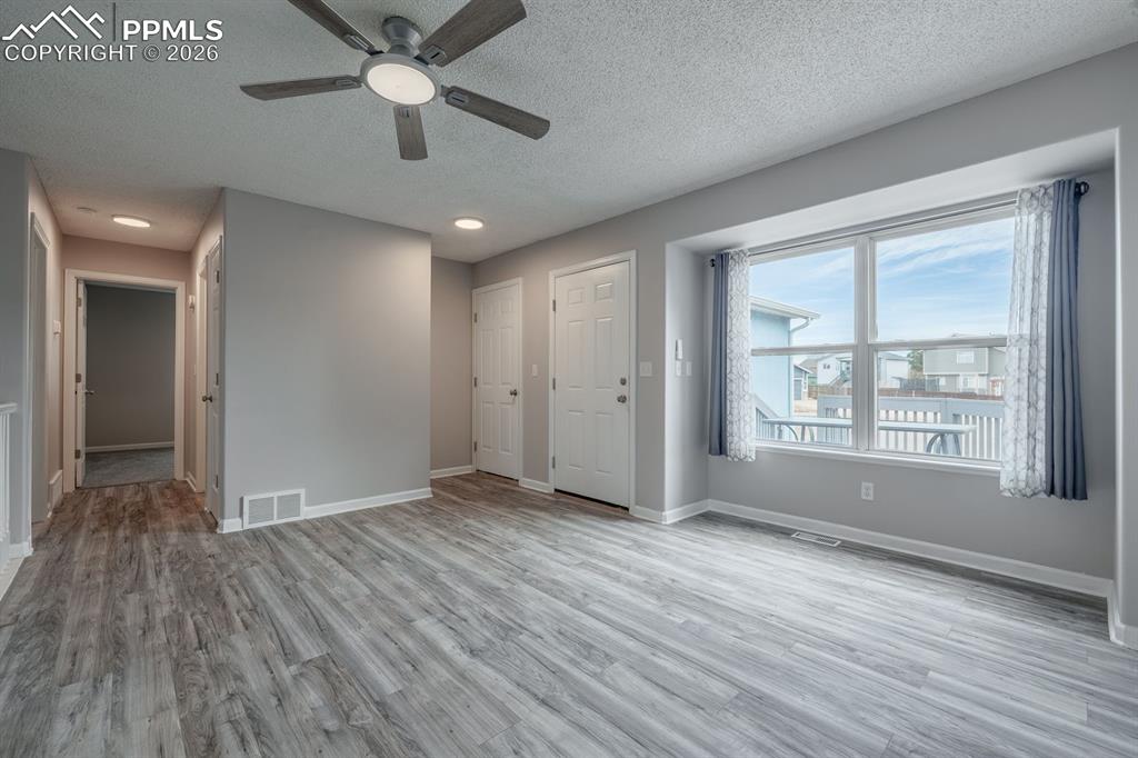 739 Memory Lane Fountain, CO 80817 - Photo 7 of 37 a view of an empty room with wooden floor and a window
