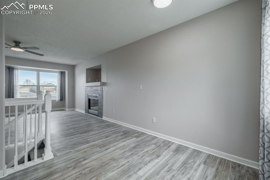 739 Memory Lane Fountain, CO 80817 - Photo 8 of 37 a view of empty room with wooden floor and fireplace