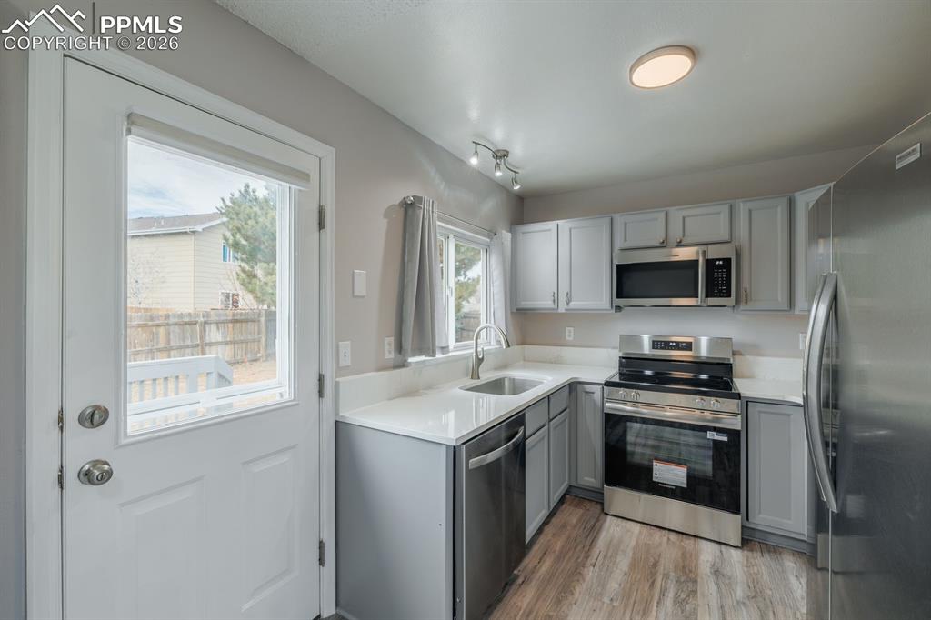 739 Memory Lane Fountain, CO 80817 - Photo 10 of 37 a kitchen with a stove a sink and a microwave