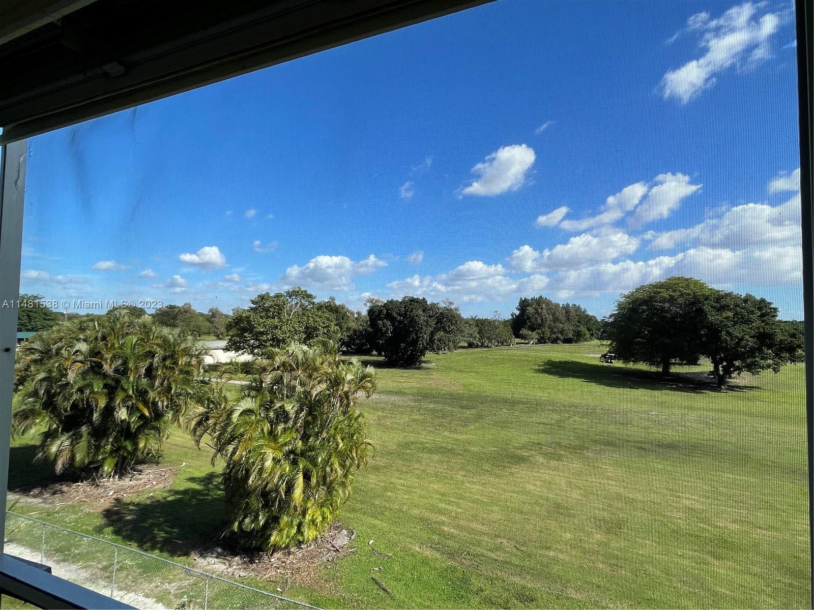 5100 Southwest 90th Avenue, Unit 303 Cooper City, FL 33328 - Photo 15 of 36 a view of a golf course with an outdoor space and seating
