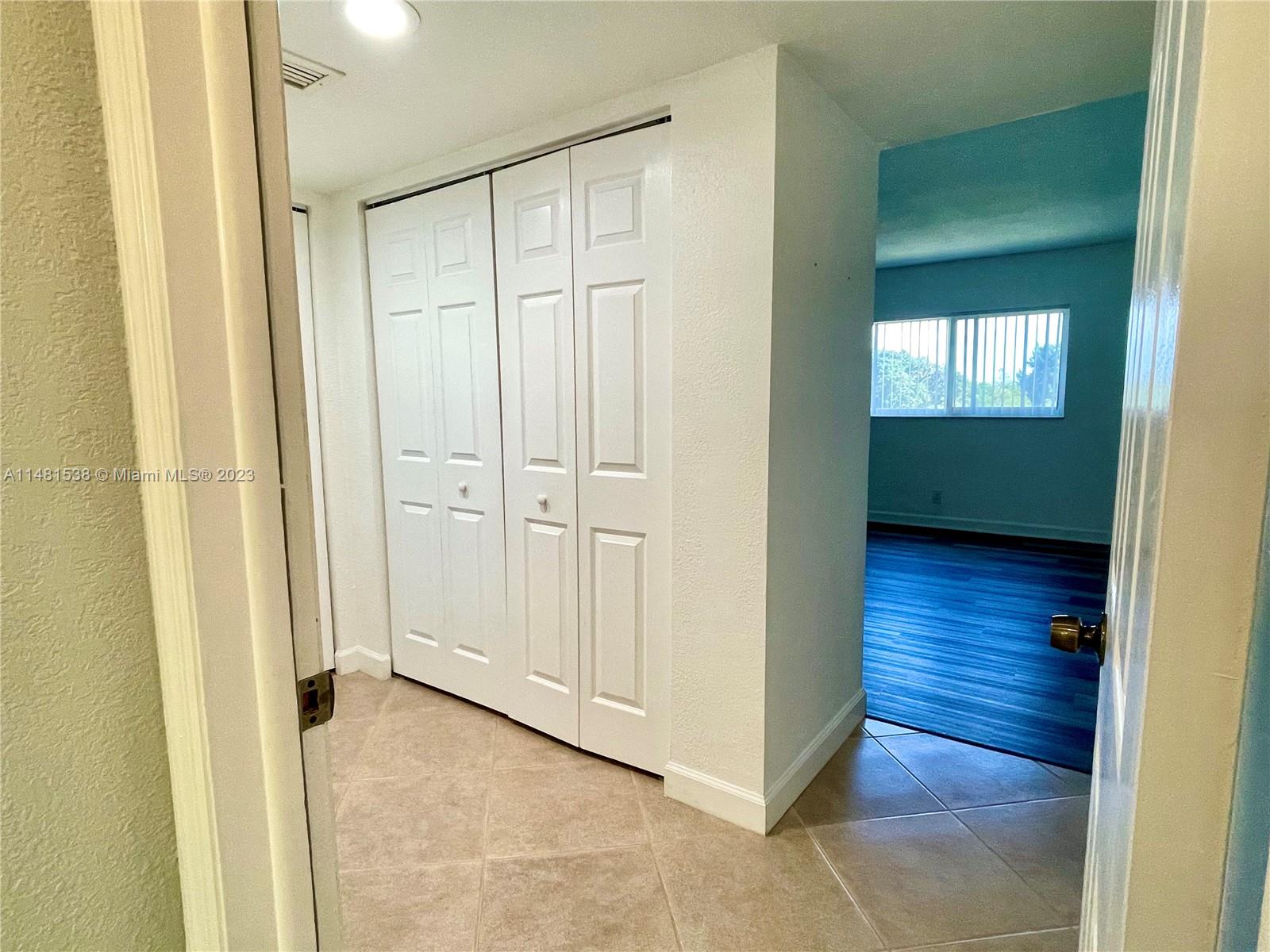 5100 Southwest 90th Avenue, Unit 303 Cooper City, FL 33328 - Photo 20 of 36 a view of a hallway with wooden floor