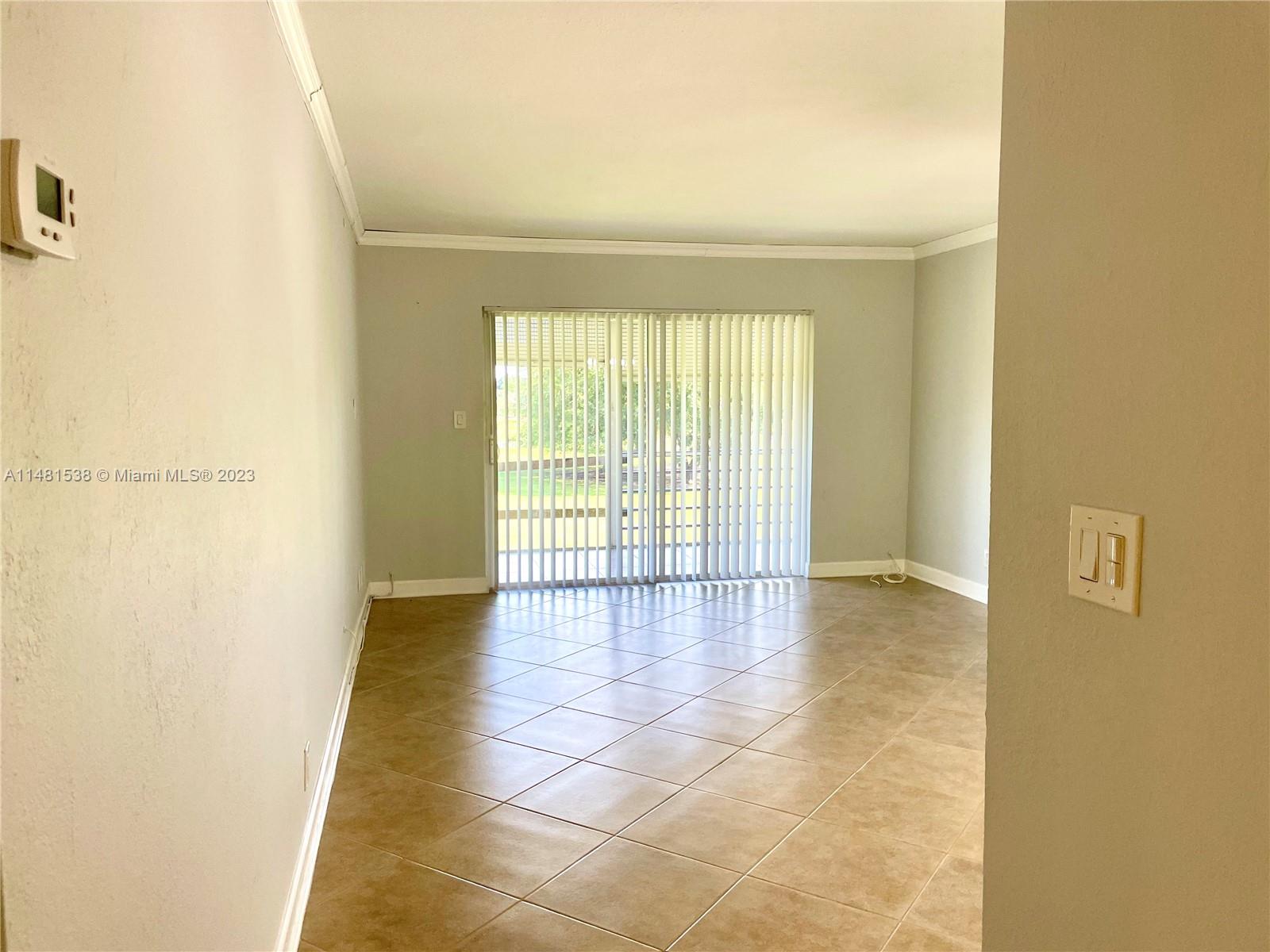 5100 Southwest 90th Avenue, Unit 303 Cooper City, FL 33328 - Photo 2 of 36 a view of an empty room with a window