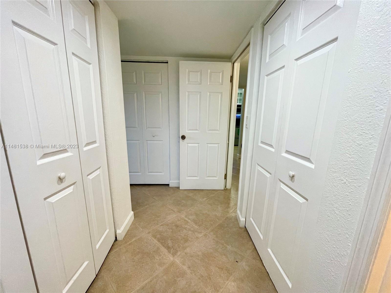 5100 Southwest 90th Avenue, Unit 303 Cooper City, FL 33328 - Photo 29 of 36 a view of a hallway with closet and door