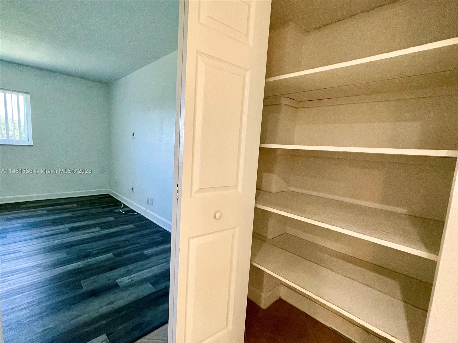 5100 Southwest 90th Avenue, Unit 303 Cooper City, FL 33328 - Photo 30 of 36 a view of an empty room with wooden floor and a window