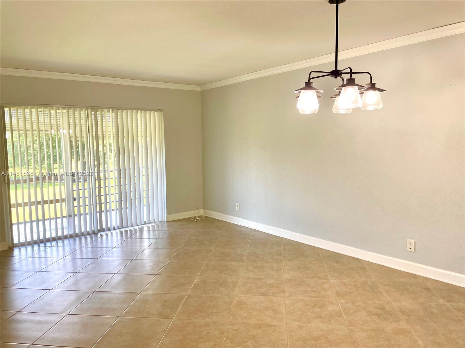 5100 Southwest 90th Avenue, Unit 303 Cooper City, FL 33328 - Photo 4 of 36 a view of an empty room with a window