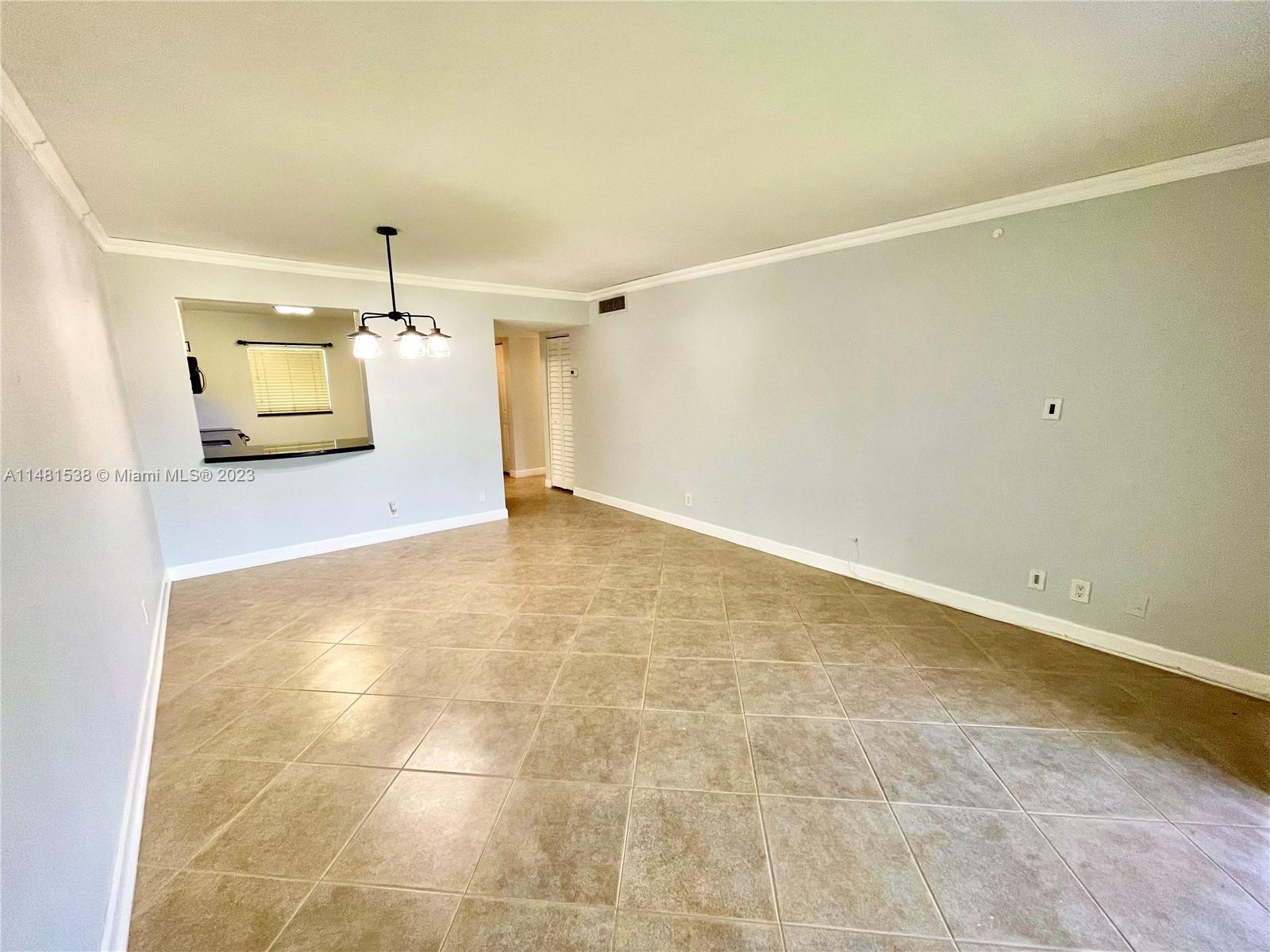 5100 Southwest 90th Avenue, Unit 303 Cooper City, FL 33328 - Photo 6 of 36 a view of a livingroom and a kitchen