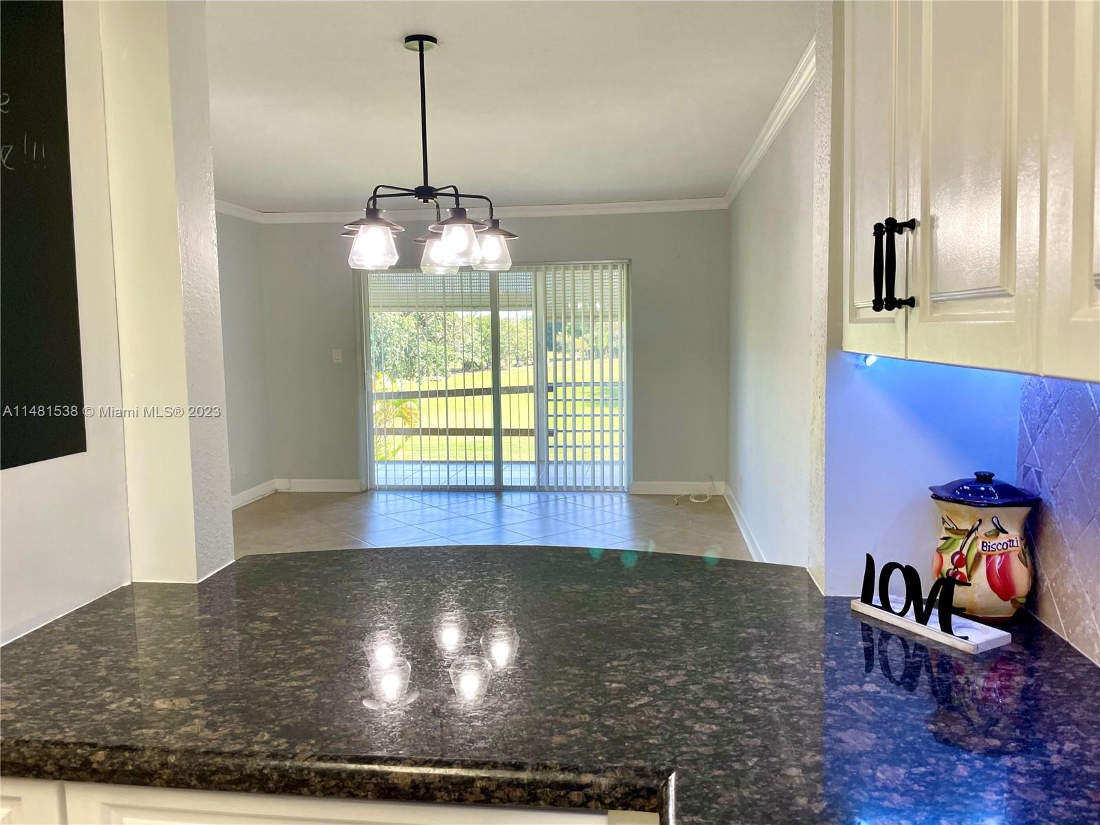 5100 Southwest 90th Avenue, Unit 303 Cooper City, FL 33328 - Photo 10 of 36 a living room with furniture and a window