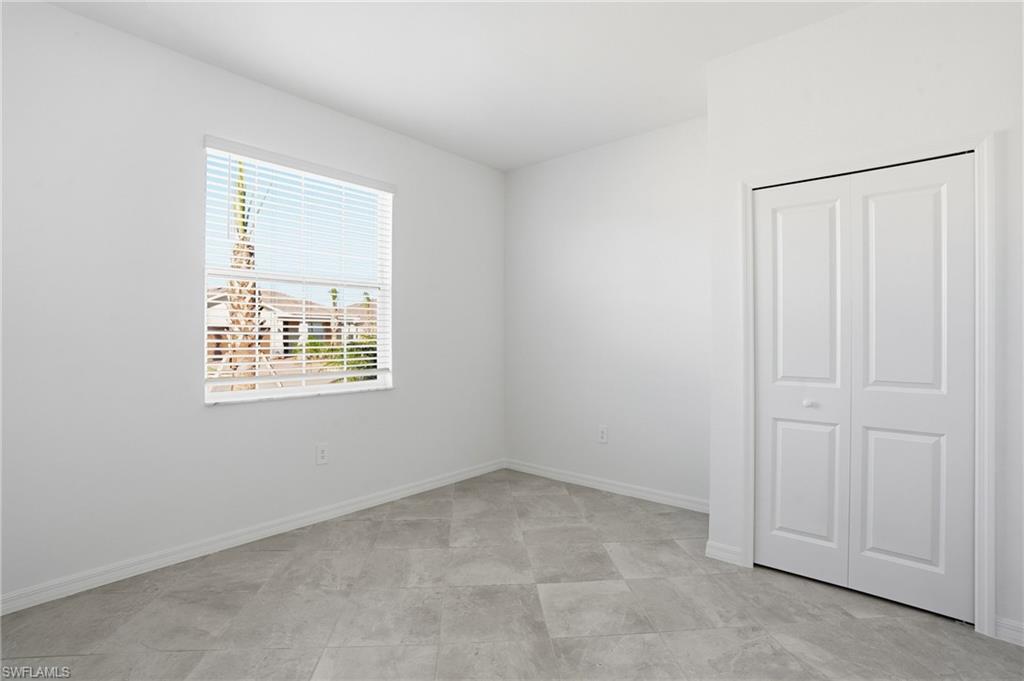 3958 Button Sage Road Alva, FL 33920 - Photo 24 of 50 Unfurnished bedroom with baseboards and a closet