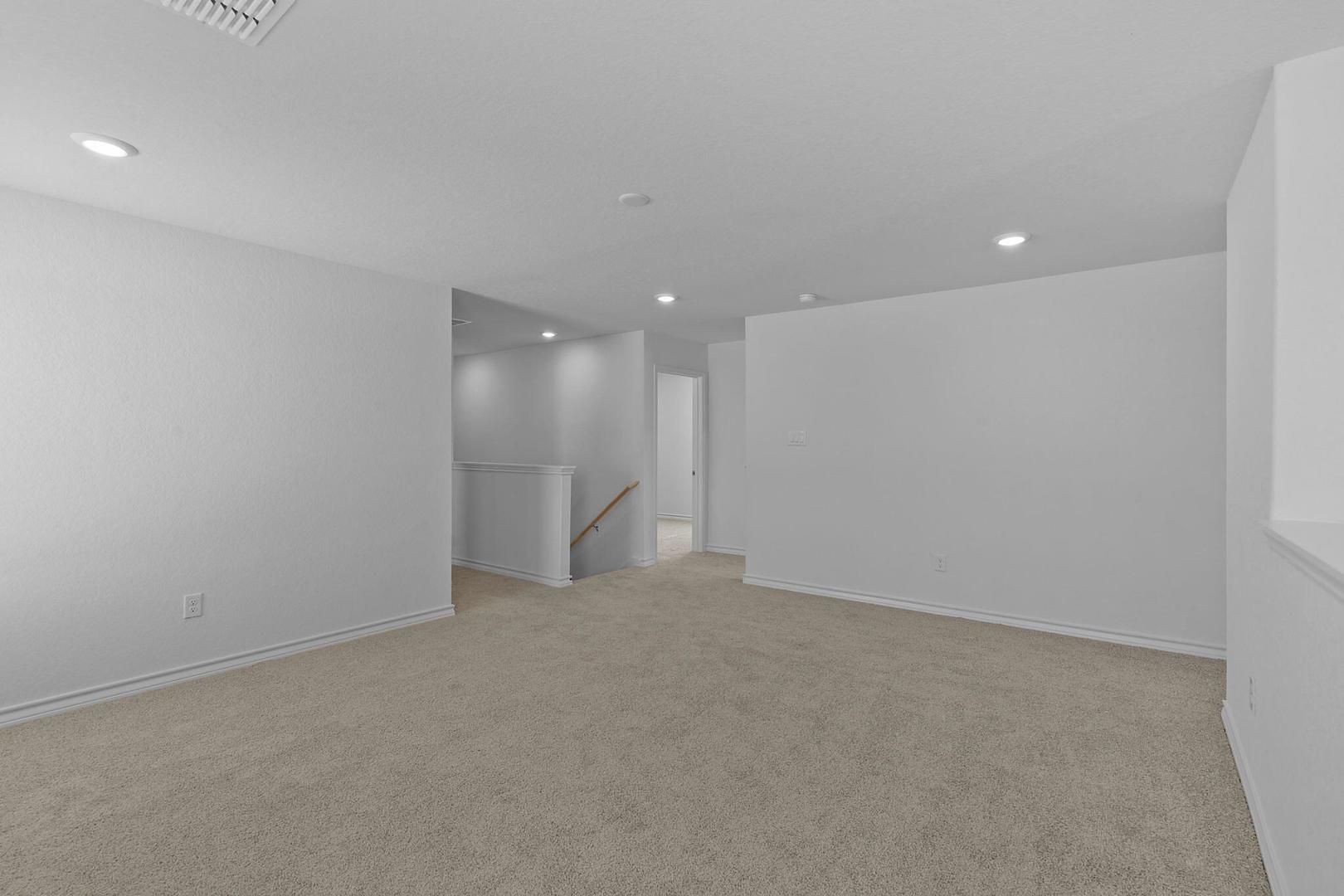 109 Hatari Trail Jarrell, TX 76537 - Photo 16 of 31 A versatile open space with plush carpeting, ready for personalized living.