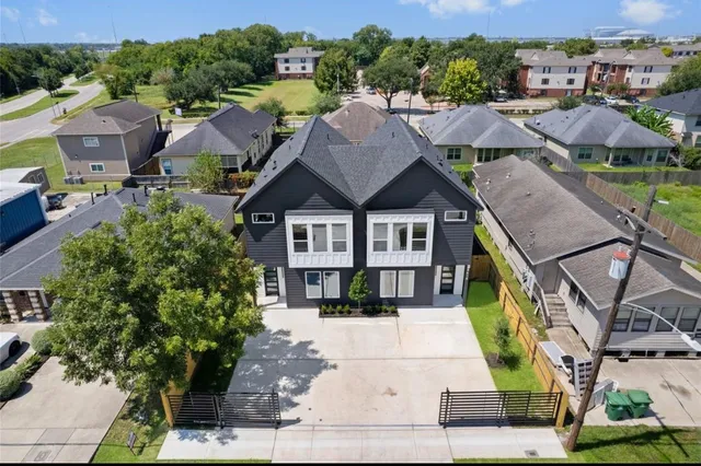 a living room with furniture a large window and a flat screen tv
