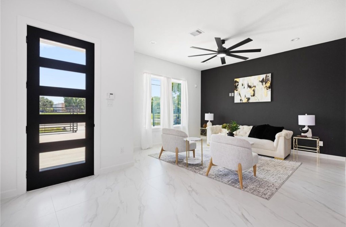 8414 Cannon Street, Unit B Houston, TX 77051 - Photo 6 of 7 a living room with furniture a large window and a flat screen tv