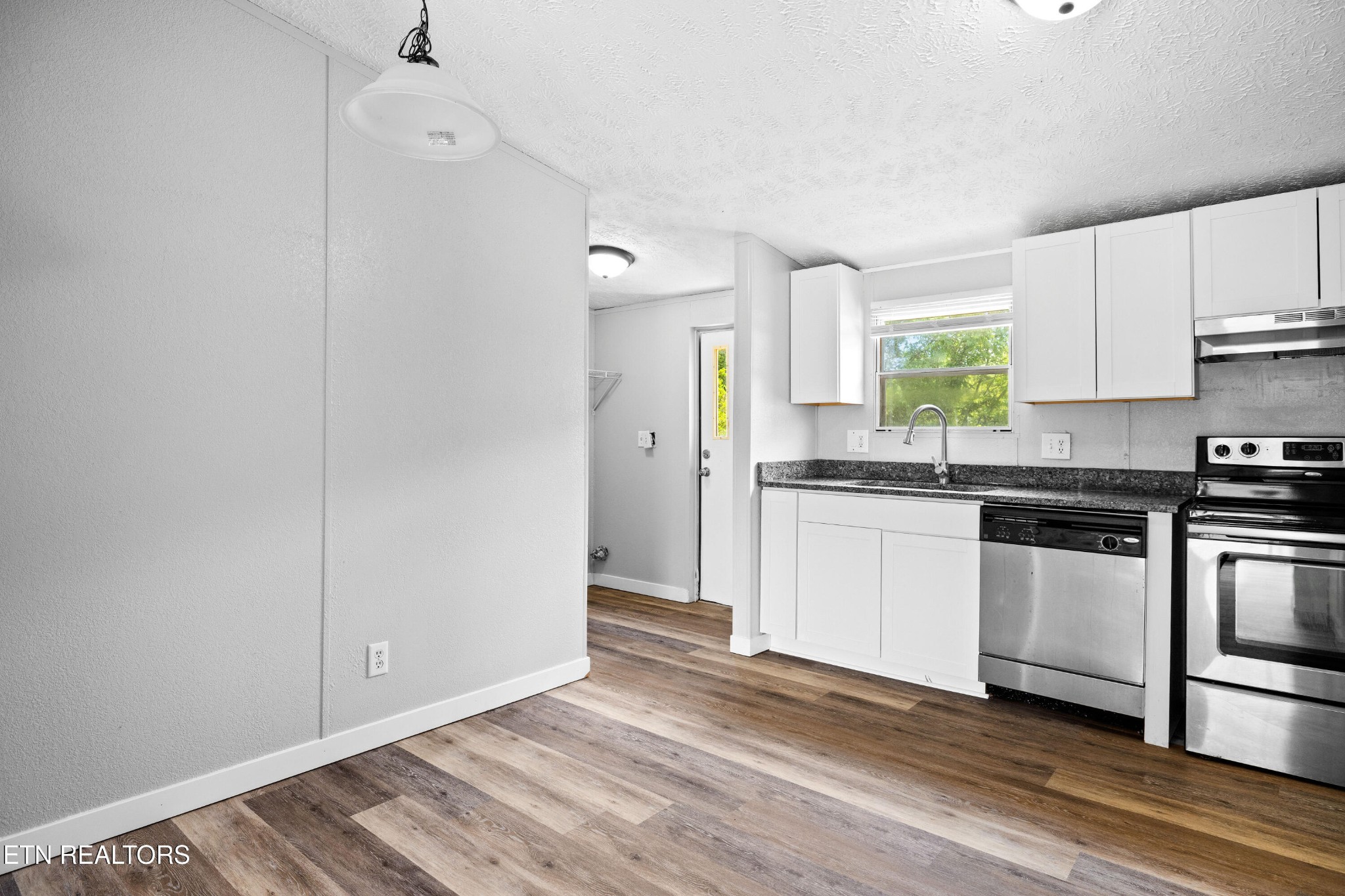 1768 Fain Cemetery Road Dandridge, TN 37725 - Photo 11 of 45 a kitchen with granite countertop a sink cabinets stainless steel appliances and a window