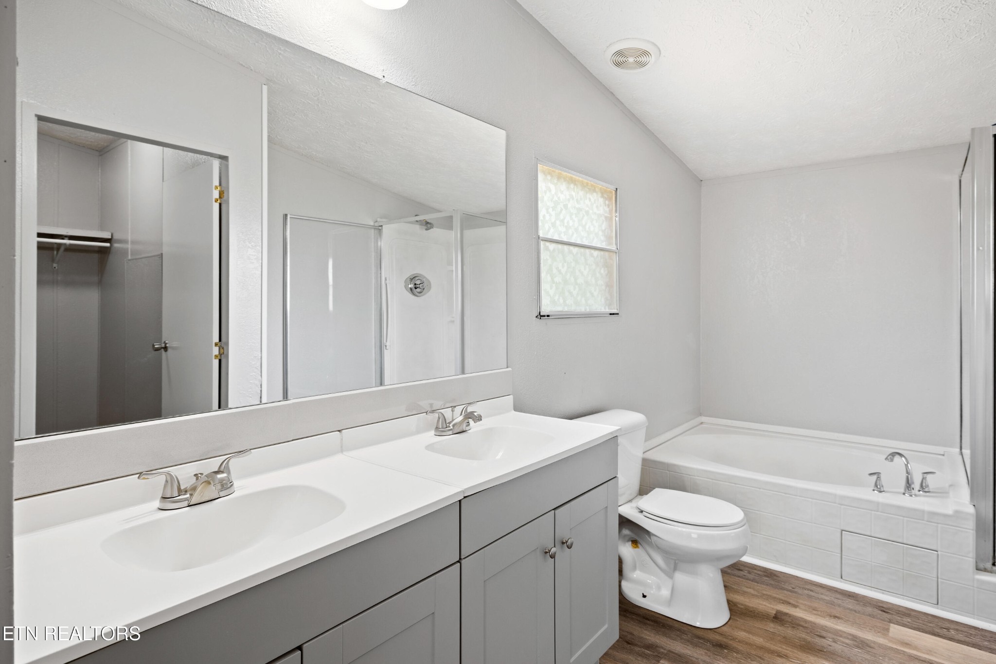 1768 Fain Cemetery Road Dandridge, TN 37725 - Photo 16 of 45 a bathroom with a toilet a sink a tub and mirror
