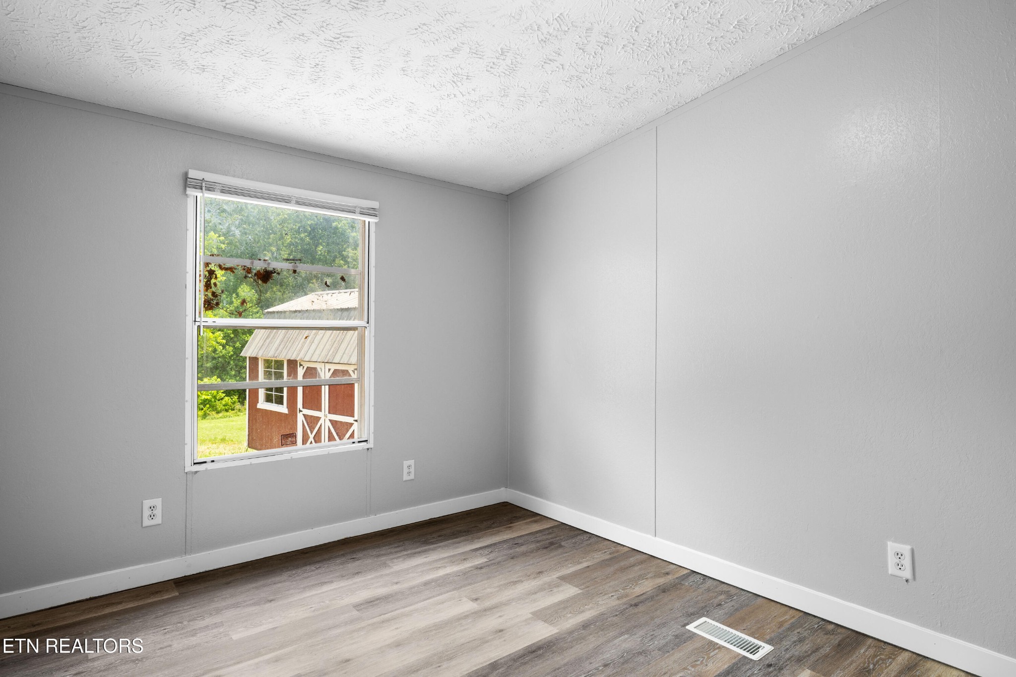 1768 Fain Cemetery Road Dandridge, TN 37725 - Photo 19 of 45 an empty room with wooden floor and windows