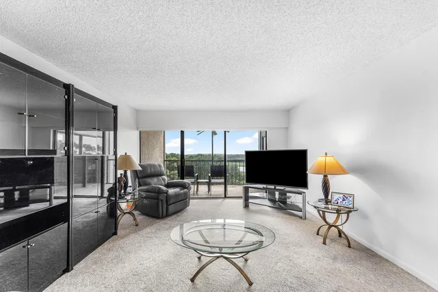 a living room with furniture and a lamp