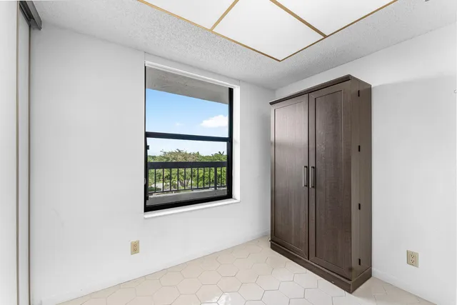 a kitchen with stainless steel appliances granite countertop a stove top oven a sink a dining table and chairs