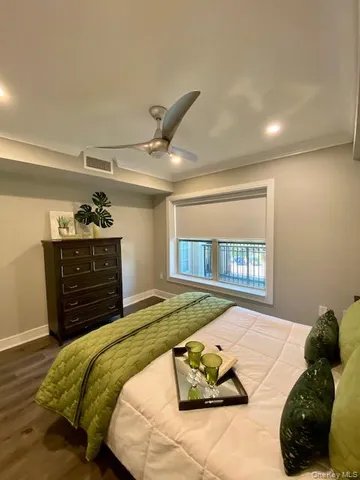 a bedroom with a bed and a dresser