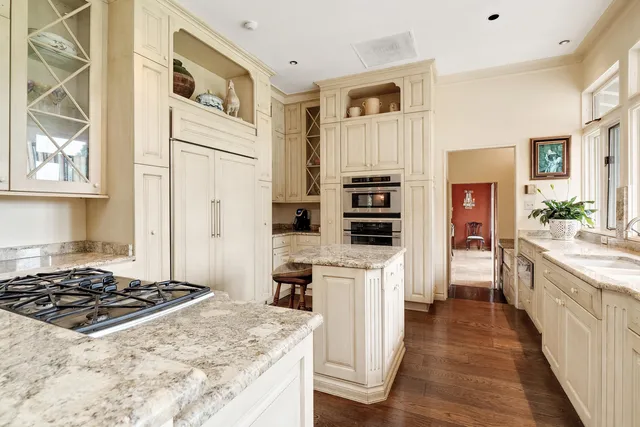 a kitchen with stainless steel appliances kitchen island granite countertop a stove a sink and a refrigerator