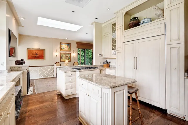 a kitchen with white cabinets and white appliances