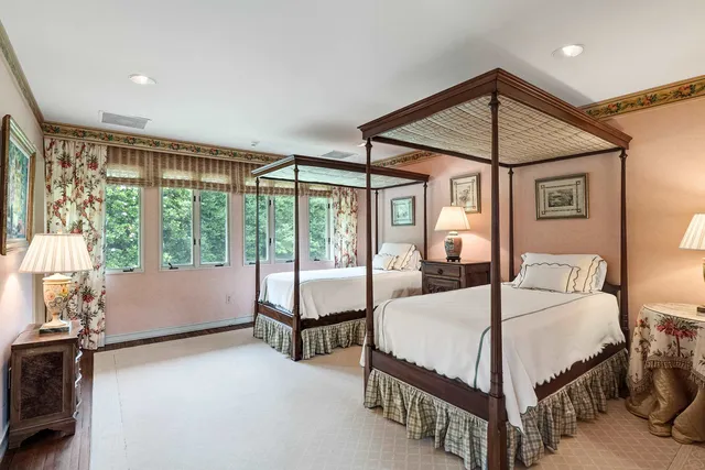 a spacious bedroom with a bed and a large window