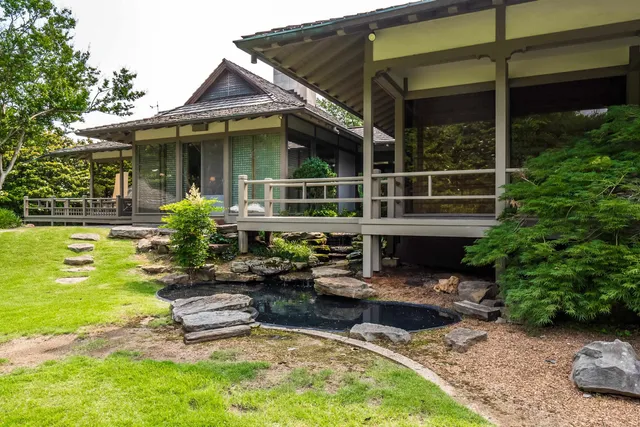 a view of a house with swimming pool and sitting area