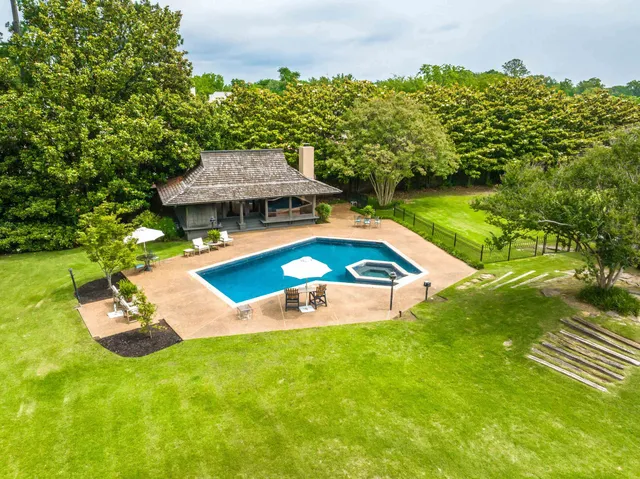 an aerial view of a house with swimming pool garden and patio