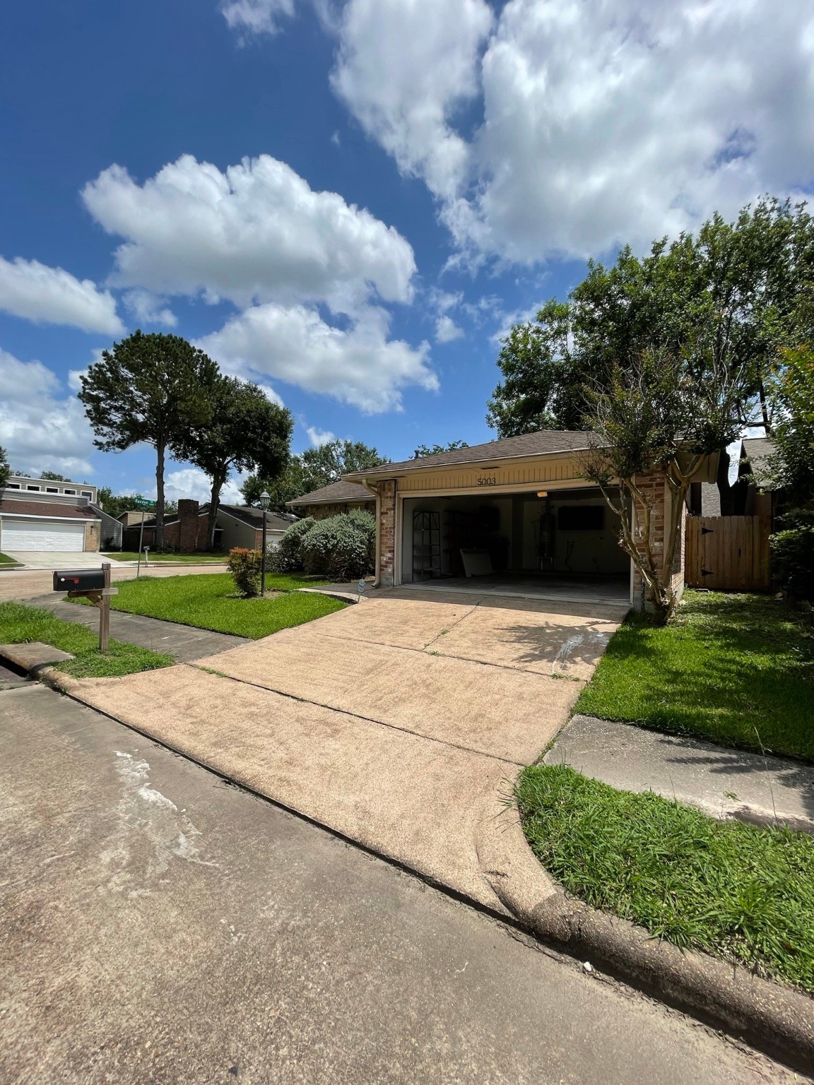 5003 Spring Forest Drive Houston, TX 77091 - Photo 17 of 37 a front view of a house with a yard and a garden