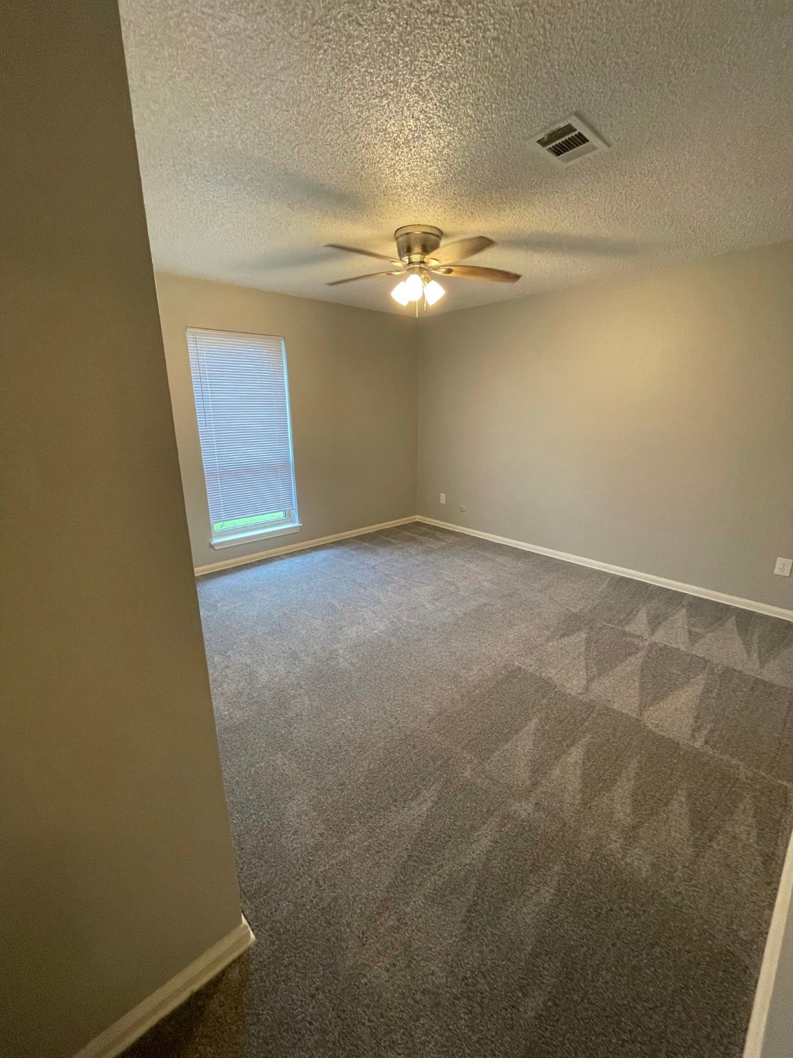 5003 Spring Forest Drive Houston, TX 77091 - Photo 19 of 37 an empty room with a ceiling fan and a window