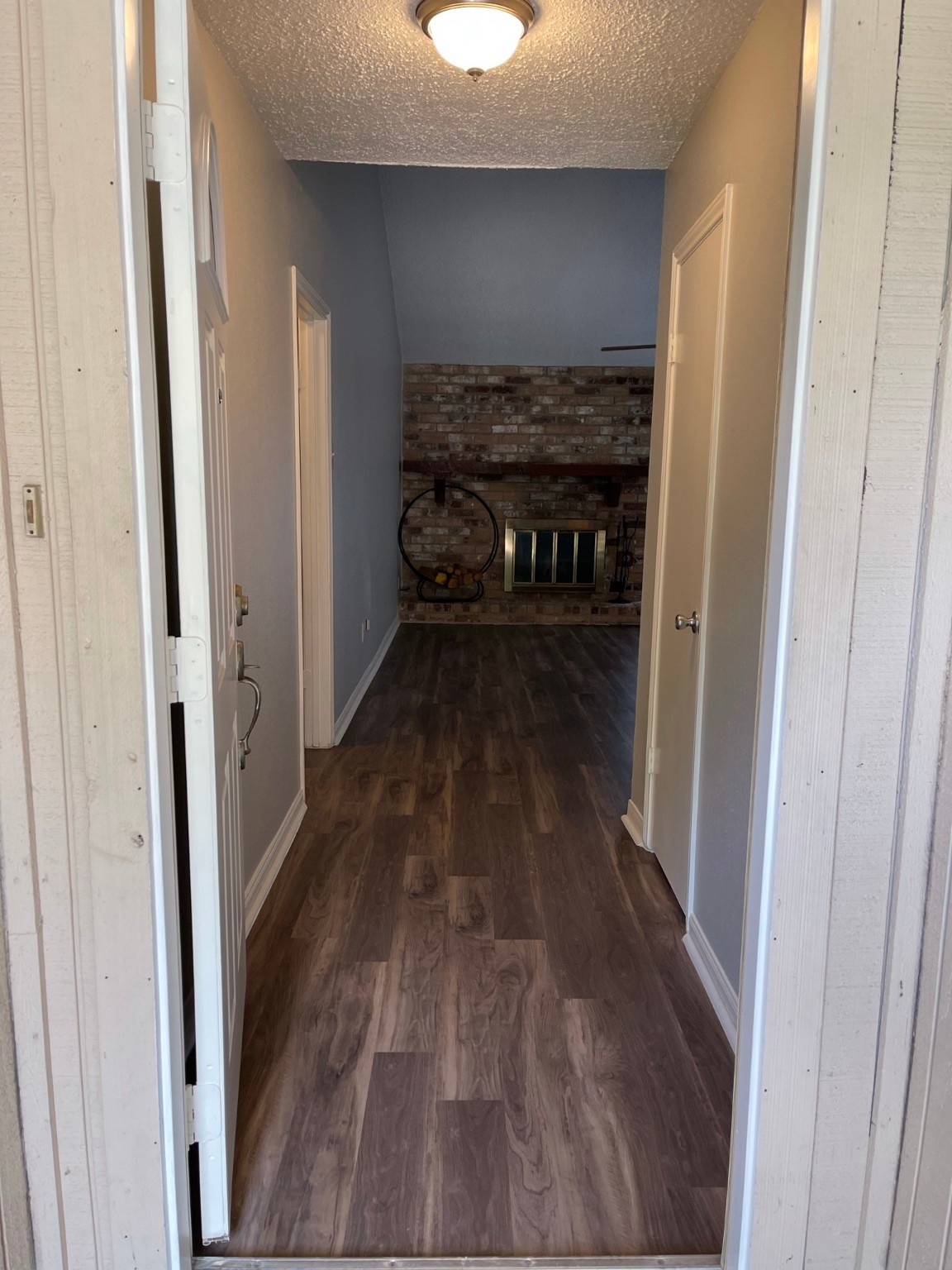 5003 Spring Forest Drive Houston, TX 77091 - Photo 28 of 37 a view of a hallway with wooden floor and a fireplace