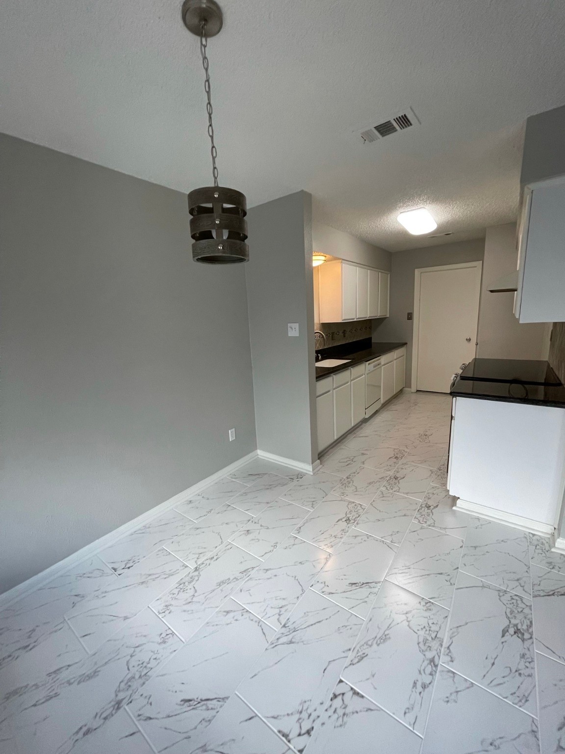 5003 Spring Forest Drive Houston, TX 77091 - Photo 33 of 37 a kitchen with granite countertop a stove a sink and a microwave