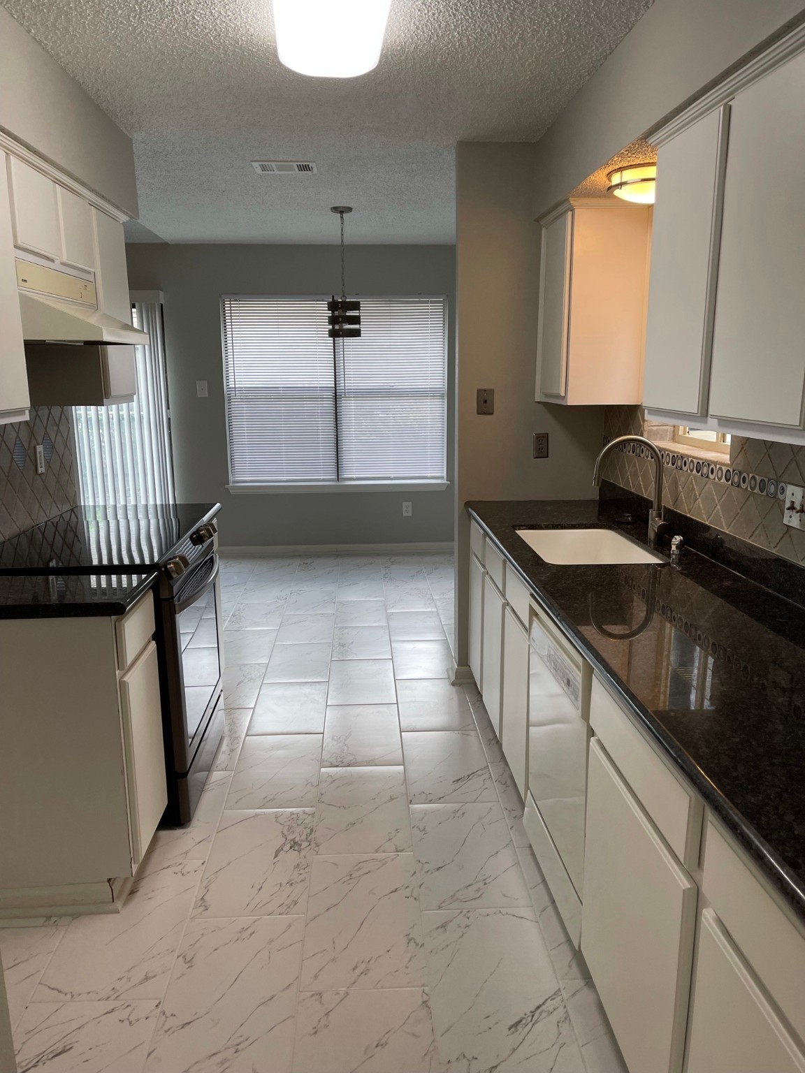 5003 Spring Forest Drive Houston, TX 77091 - Photo 35 of 37 a kitchen with a sink stove and cabinets