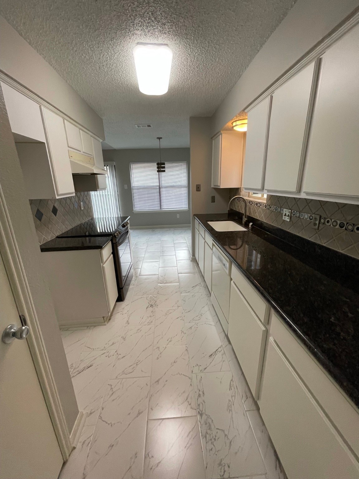 5003 Spring Forest Drive Houston, TX 77091 - Photo 36 of 37 a large white kitchen with a sink and cabinets