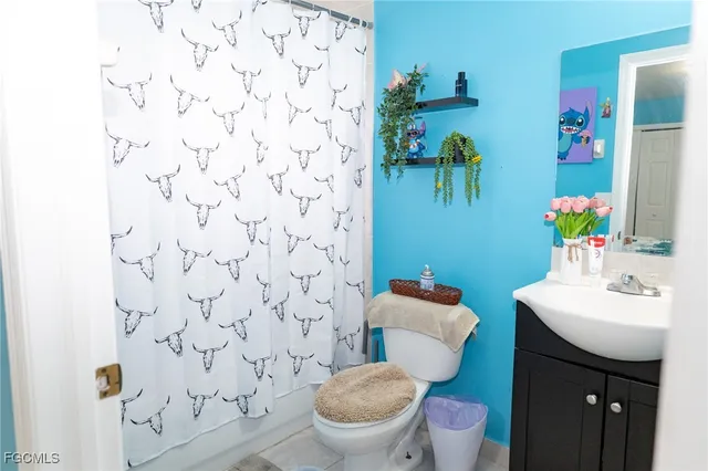 a bathroom with a sink toilet and mirror