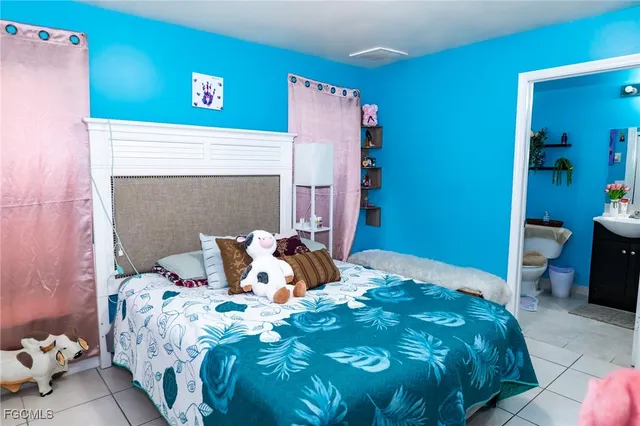 a bedroom with a bed and a potted plant