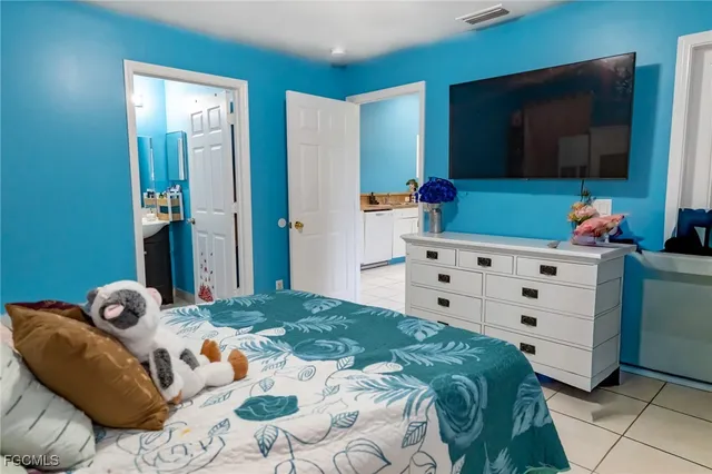 a bedroom with a bed and flat screen tv