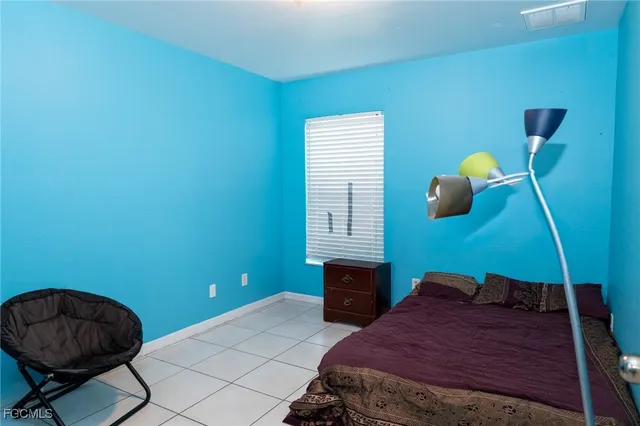 a bedroom with a bed and a chair