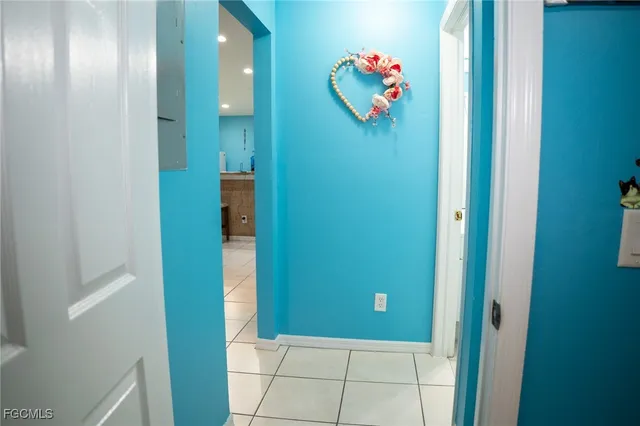 a view of a hallway with painting and closet