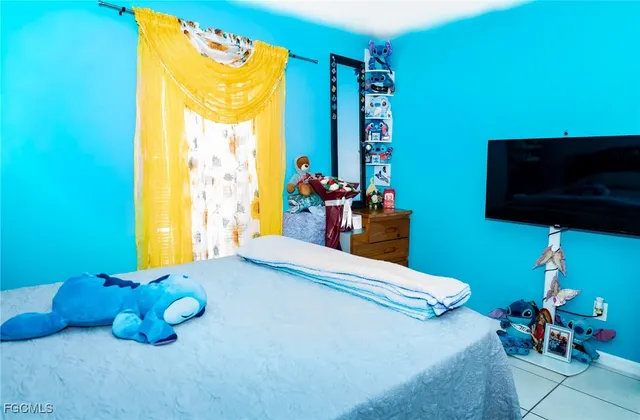 a bedroom with a bed and a tv