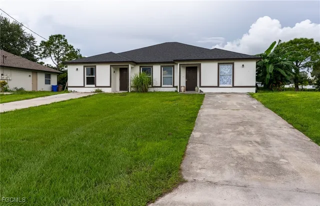 a front view of a house with a yard