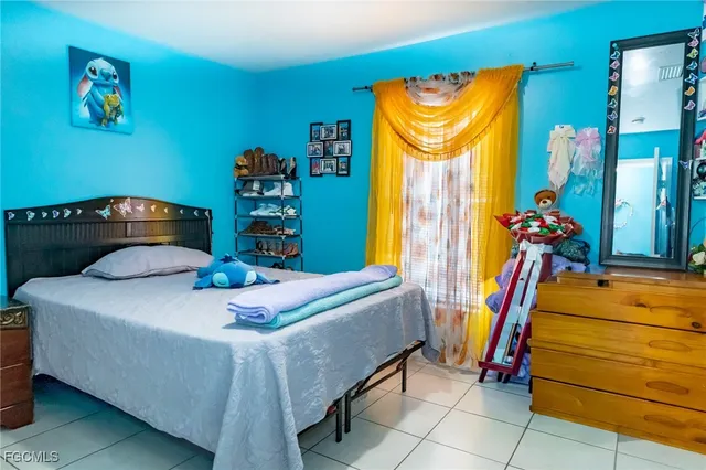 a bedroom with a bed and dresser