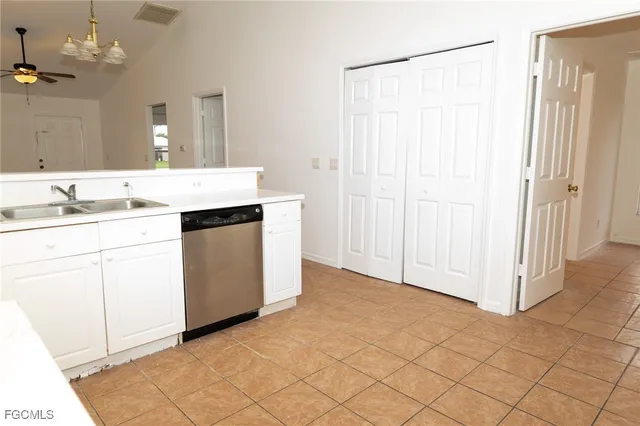 a kitchen with a sink cabinets and window
