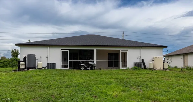 a front view of a house with a garden and yard