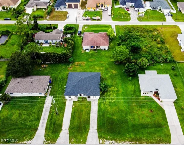 an aerial view of house with yard swimming pool and outdoor seating