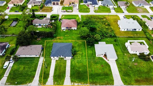 an aerial view of house with a yard