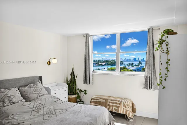 a bedroom with furniture and a window